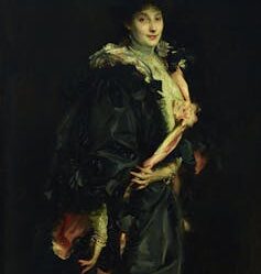 Lady Sassoon in a black cape.
