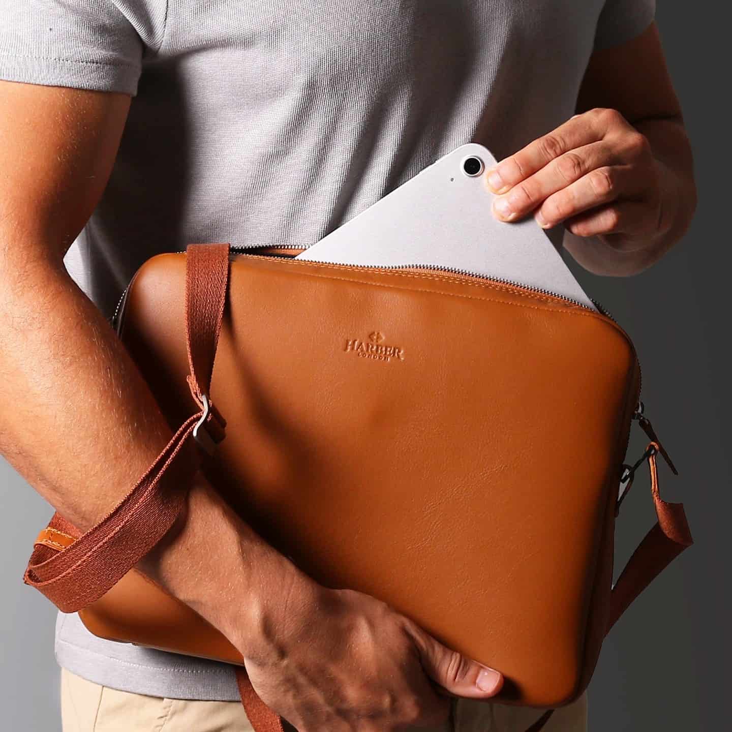 man carrying a leather messenger bag by harber london