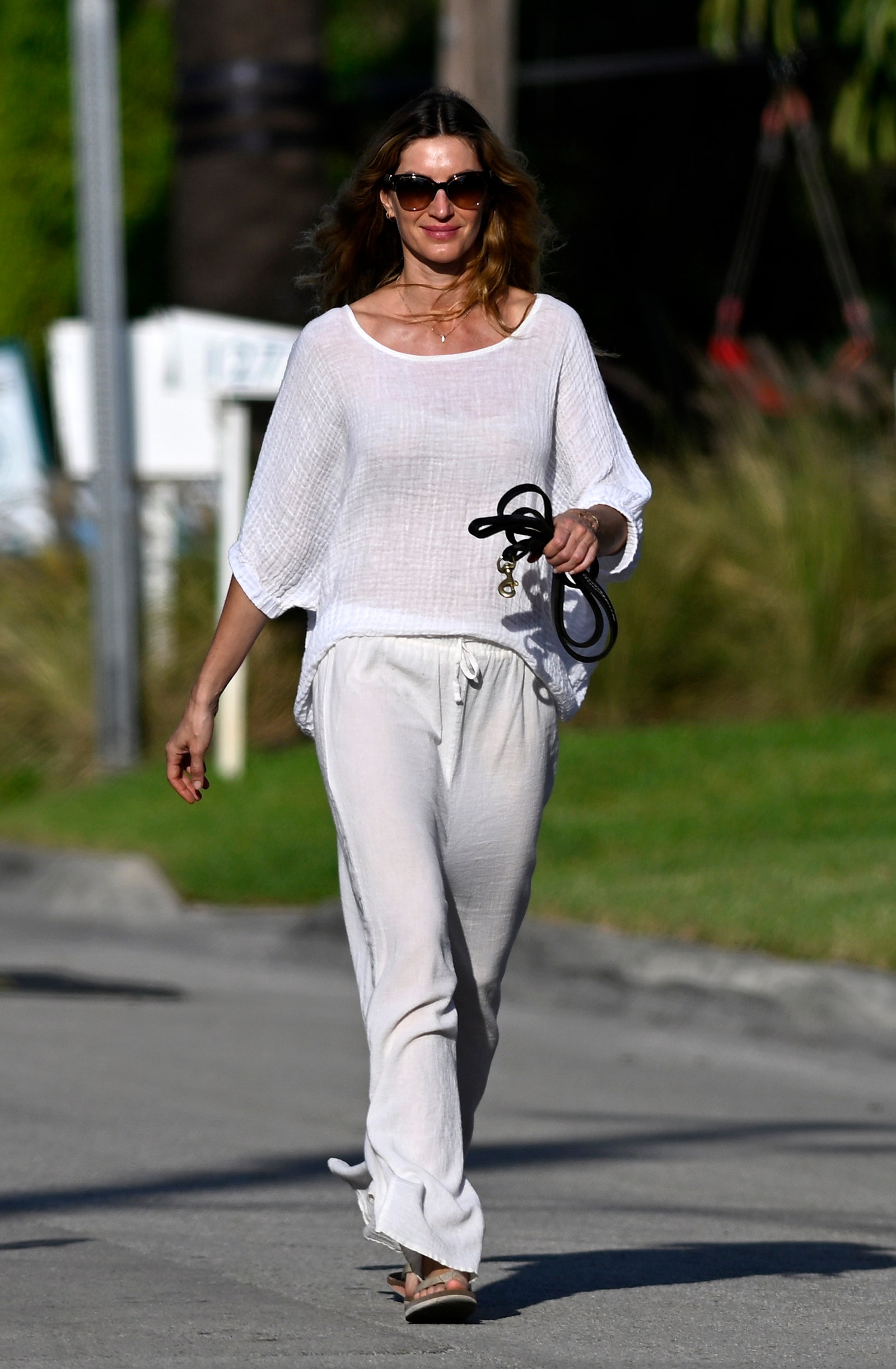 Image may contain Gisele Bündchen Clothing Pants Person Walking Adult Pedestrian Accessories Jewelry and Necklace