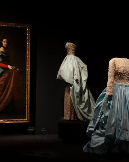 Evening ensemble of cotton tulle dress, metal thread embroidery on rayon satin, and silk taffeta overskirt, designed by Balenciaga, and _St. Isabella of Portugal_ by Francisco de Zurbarán.