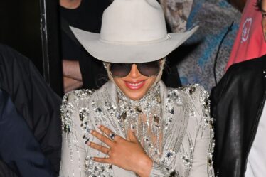 Beyonce appears at a fashion show in a sparkly silver suit cowboy hat and turquoise studded French manicure.