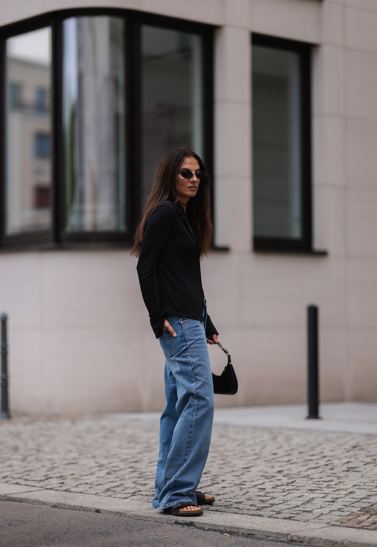 a woman in birkenstock sandals and baggy jeans