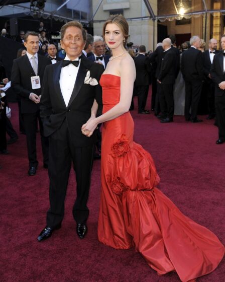 A woman in a red dress and a man in a tuxedo.