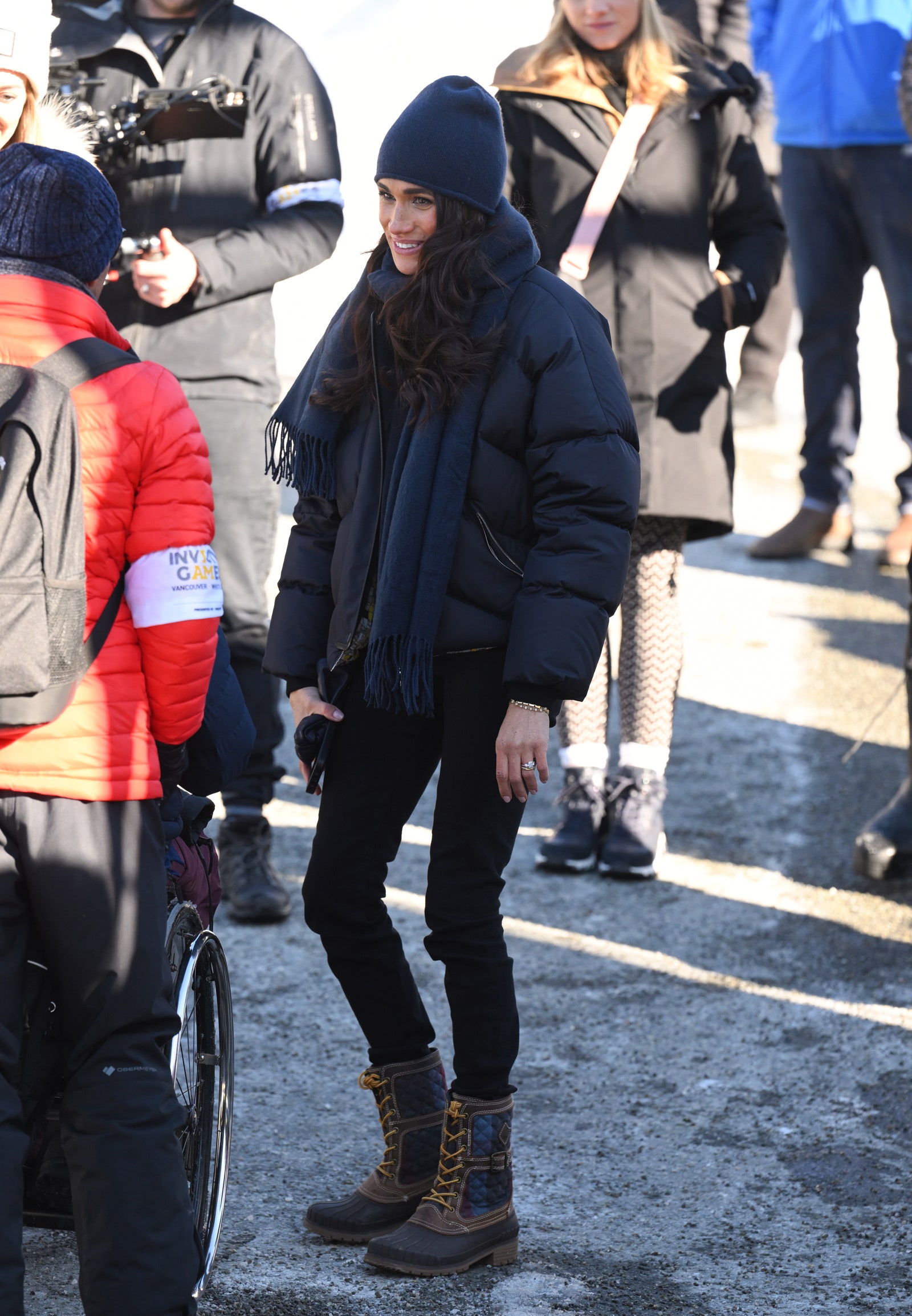 Image may contain Meghan Duchess of Sussex Clothing Footwear Shoe Hat Person Coat Pants Adult Sneaker and Glove
