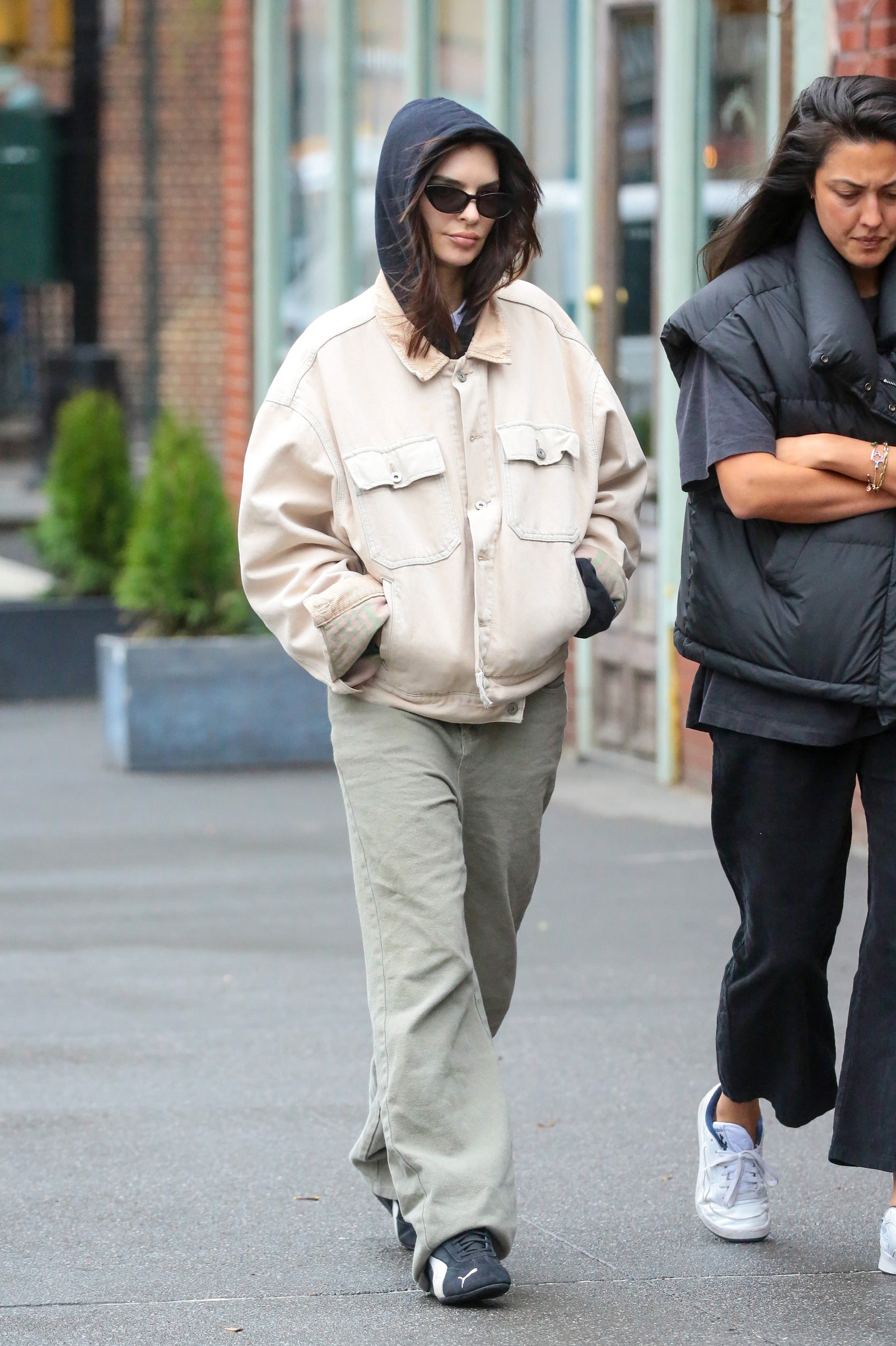 Image may contain Emily Ratajkowski Pedestrian Person Clothing Pants Glove Adult Footwear Shoe and Accessories