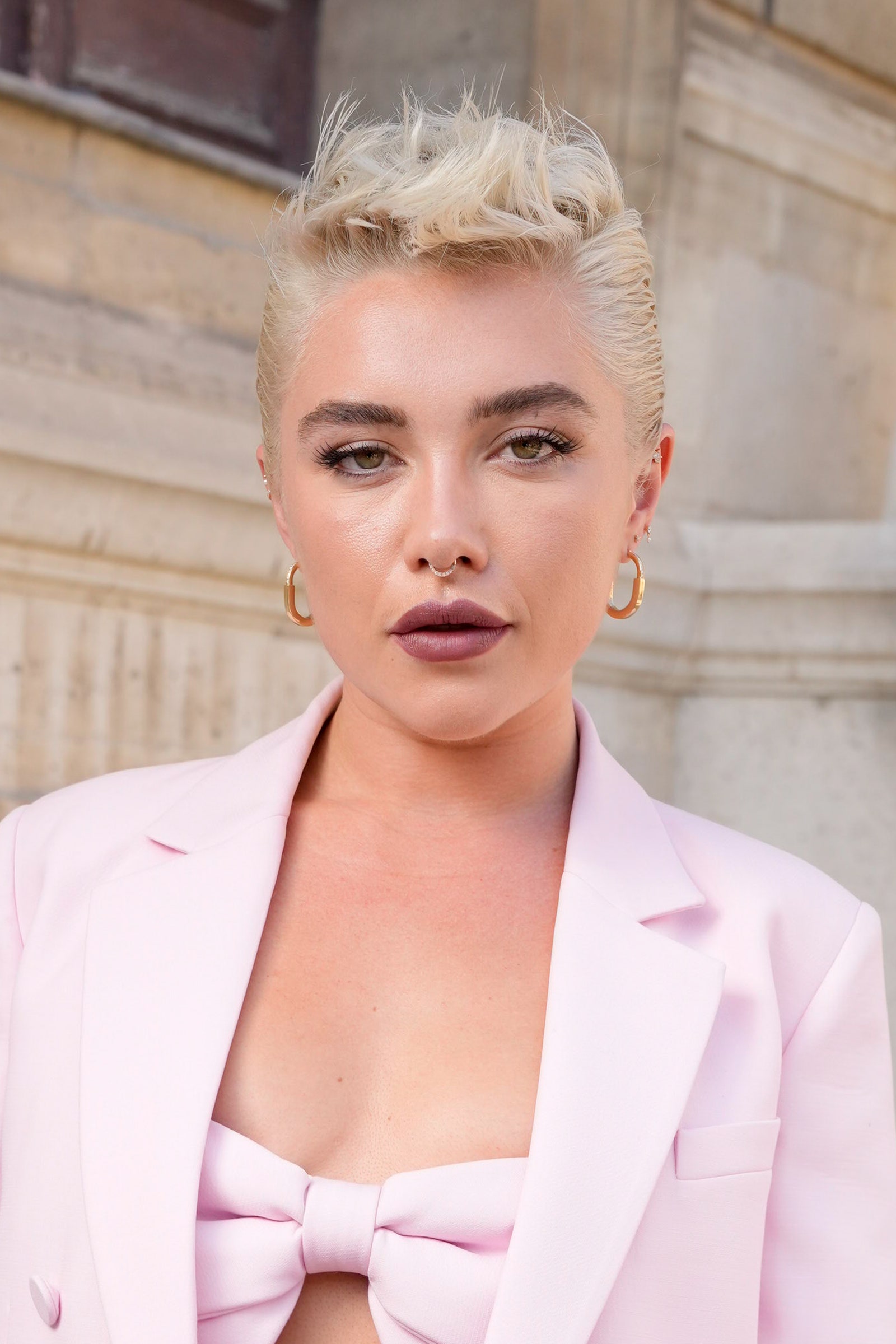 Image may contain Florence Pugh Blonde Hair Person Adult Accessories Formal Wear Tie Clothing Coat and Pixie Cut