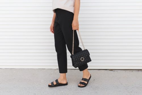 woman wearing black flat sandals