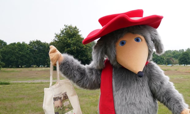 A womble on Wimbledon Common holding a tote bag