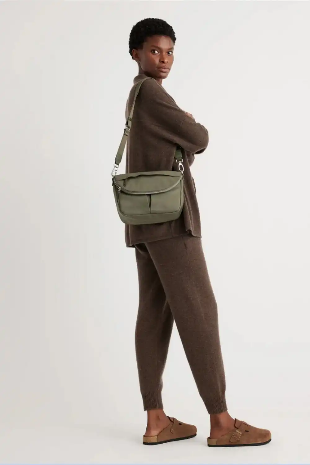 Model wears green crossbody bag.