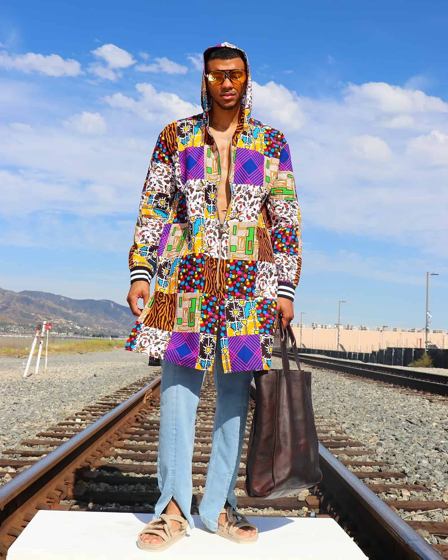 Hippie fashion: man in a hooded long jacket