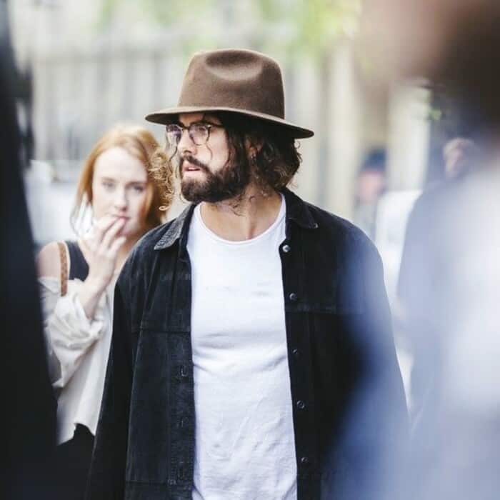 man wearing a fedora hat and black denim jacket