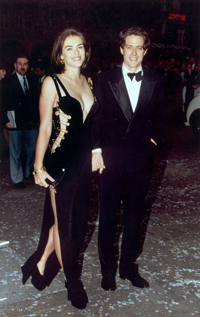 Hugh Grant and Elizabeth Hurley in Versace, May 1994 | Photo by Gareth Davies/Mission Pictures/Getty Images