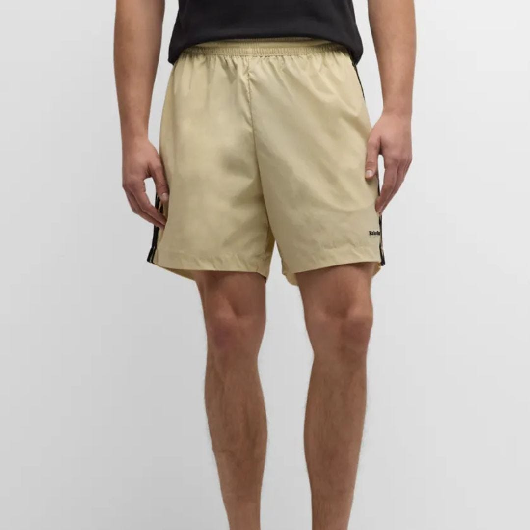 lower half of man wearing  tan adidas originals x wales bonner soccer shorts