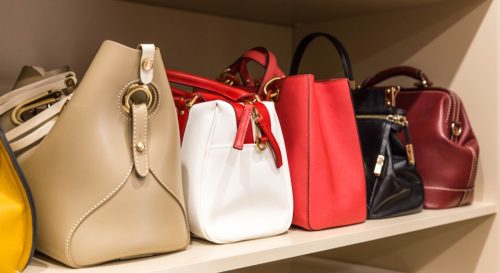 Row of Purses Sitting in a Closet 
