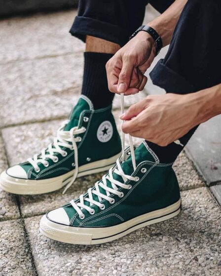 tying the shoelace of a classic chuck 70 by converse