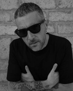man in black t-shirt wearing a ray-ban wayfarer