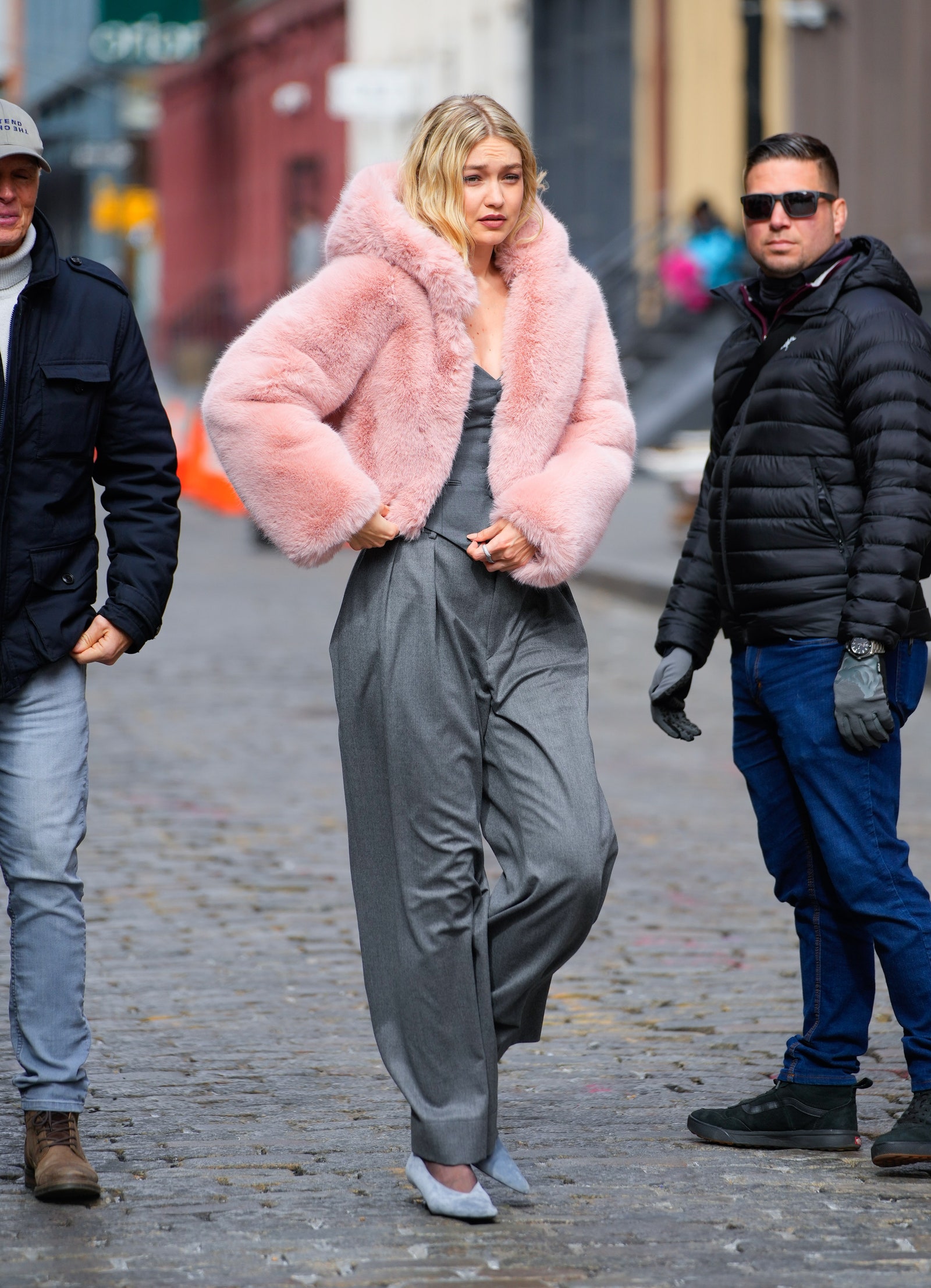 Image may contain Gigi Hadid Clothing Pants Glove Adult Person Footwear Shoe Walking Hat Pedestrian and Coat