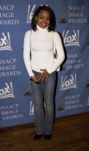 Image may contain Kyla Pratt Clothing Pants Person Standing Adult Accessories Bag Handbag Jeans Footwear and Shoe