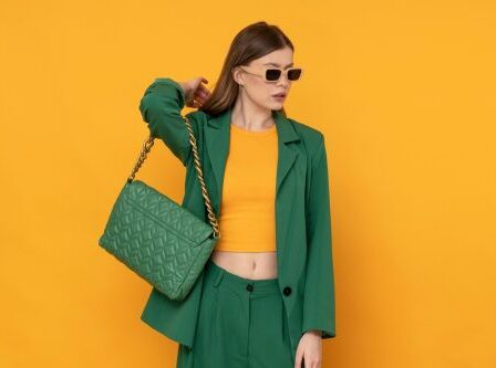 Yellow and green fashion concept with young stylish woman wearing suit and purse