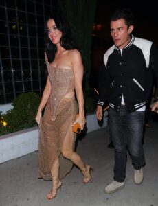 Image may contain Orlando Bloom Katy Perry Adult Person Clothing Footwear High Heel Shoe Body Part and Hand