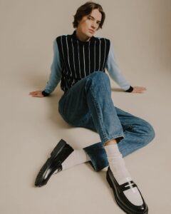 man sitting on the floor wearing a pair of arezzo dice loafers