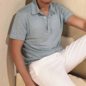 man wearing a gray shirt and white trousers