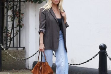 Image may contain Sienna Miller Clothing Pants Jeans Accessories Bag Handbag Adult Person Blazer Coat and Jacket