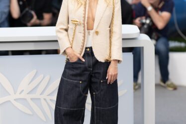 Image may contain Sienna Miller Clothing Pants Jeans Adult Person Camera Electronics Footwear Shoe and Hat