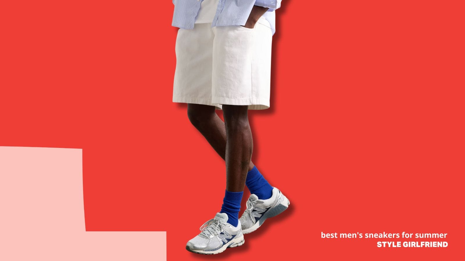 lower half of a man in a light blue shirt and off-white shorts, with New Balance sneakers and blue socks