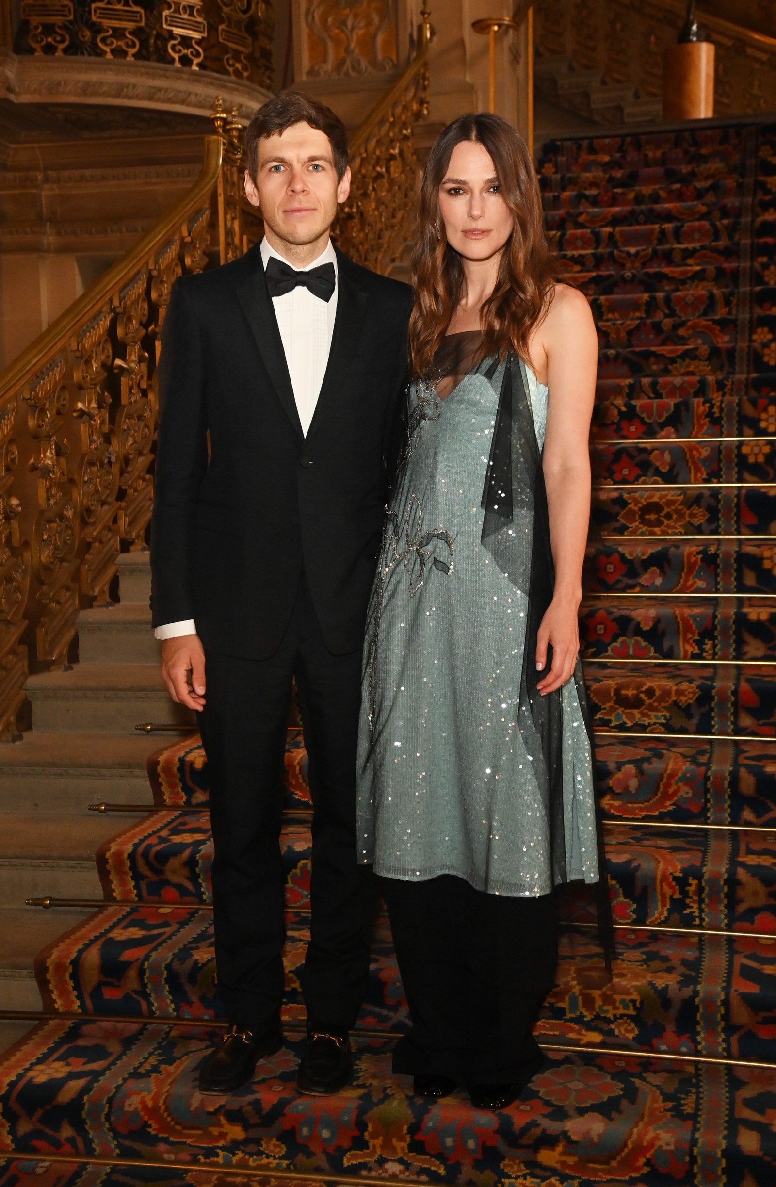 Image may contain James Righton Keira Knightley Formal Wear Clothing Suit Blazer Coat Jacket and Architecture