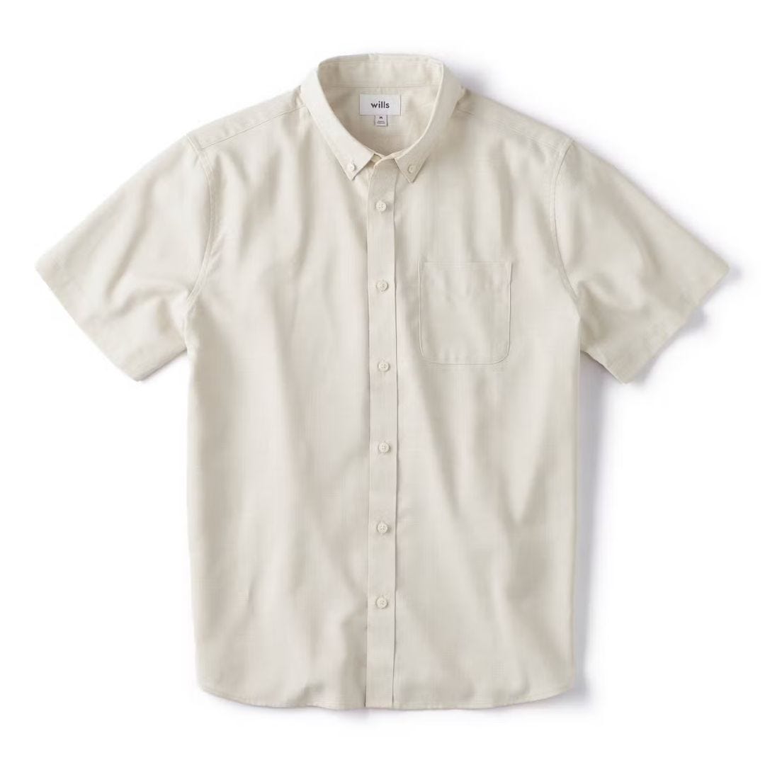 off-white short sleeve button up shirt against a blank background, included in a roundup of light colored outfits for men