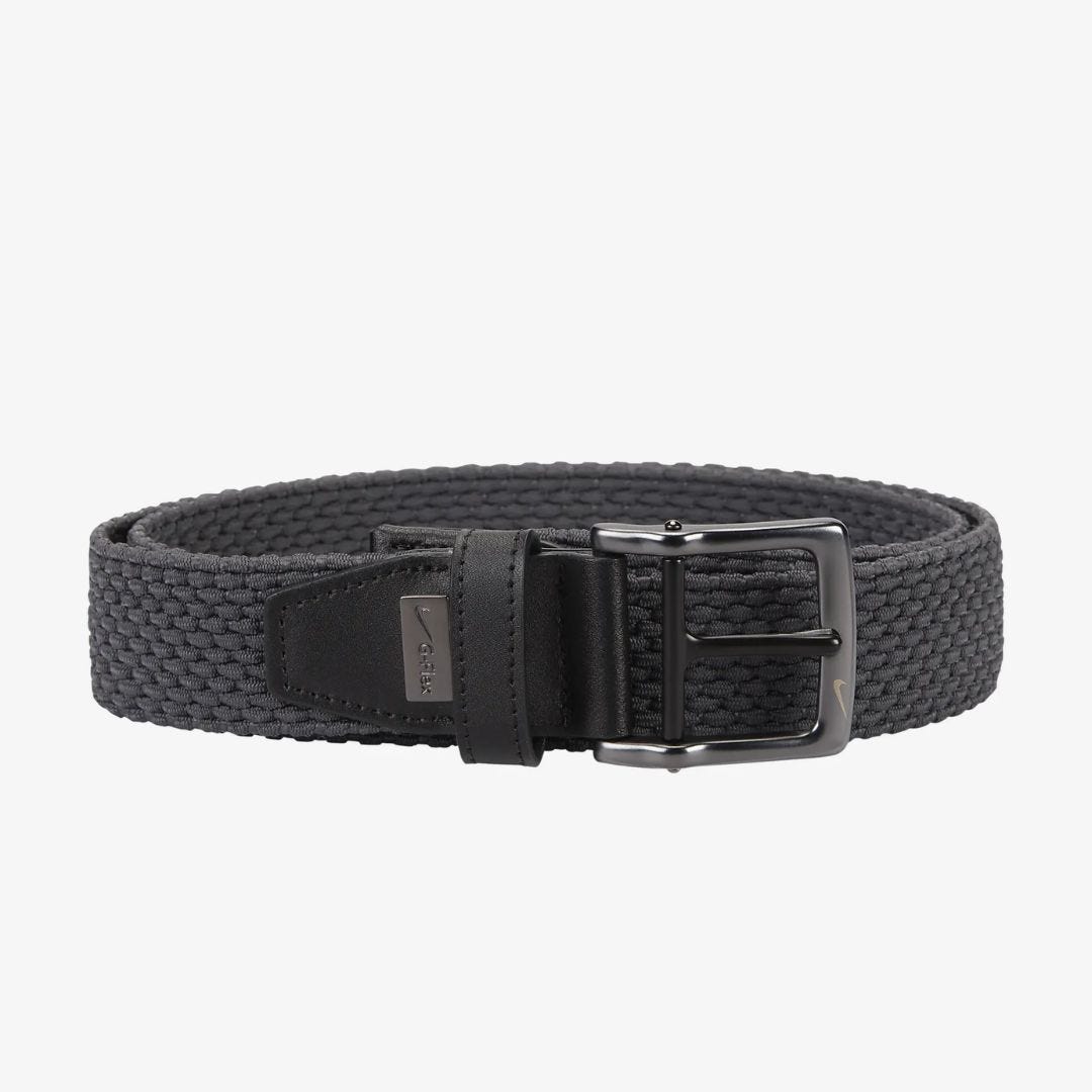 a black woven belt coiled against a white background