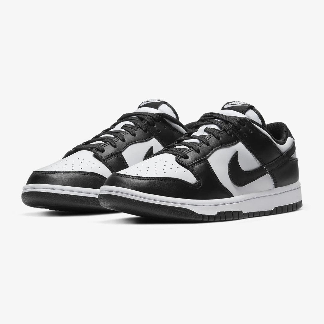 a pair of nike dunk low retro sneakers in black and white