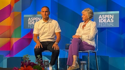 Two people on stage at a panel discussion