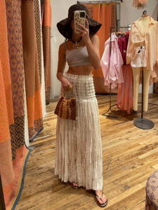 Image may contain Clothing Sleeve Beachwear Adult Person Accessories Bag Handbag Skirt and Coat
