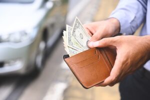 man taking cash out of wallet