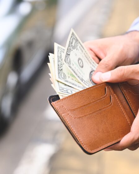 man taking cash out of wallet