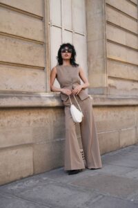 PARIS FRANCE  JUNE 08 Xiayan Guo wears sunglasses a sleeveless beige blazer jacket from Lovechild1979 matching flared...