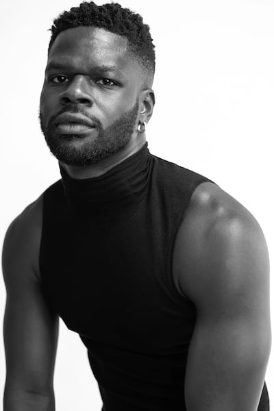 Black and white headshot of Kingsley Gbadegesin in a black high neck tank top.