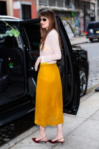 Image may contain Dakota Johnson Clothing Footwear High Heel Shoe Skirt Person Teen Accessories Glasses and Car