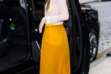 Image may contain Dakota Johnson Clothing Footwear High Heel Shoe Skirt Person Teen Accessories Glasses and Car