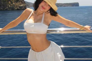 Image may contain Clothing Swimwear Hat Adult Person Sun Hat Beachwear Face Head Photography and Portrait