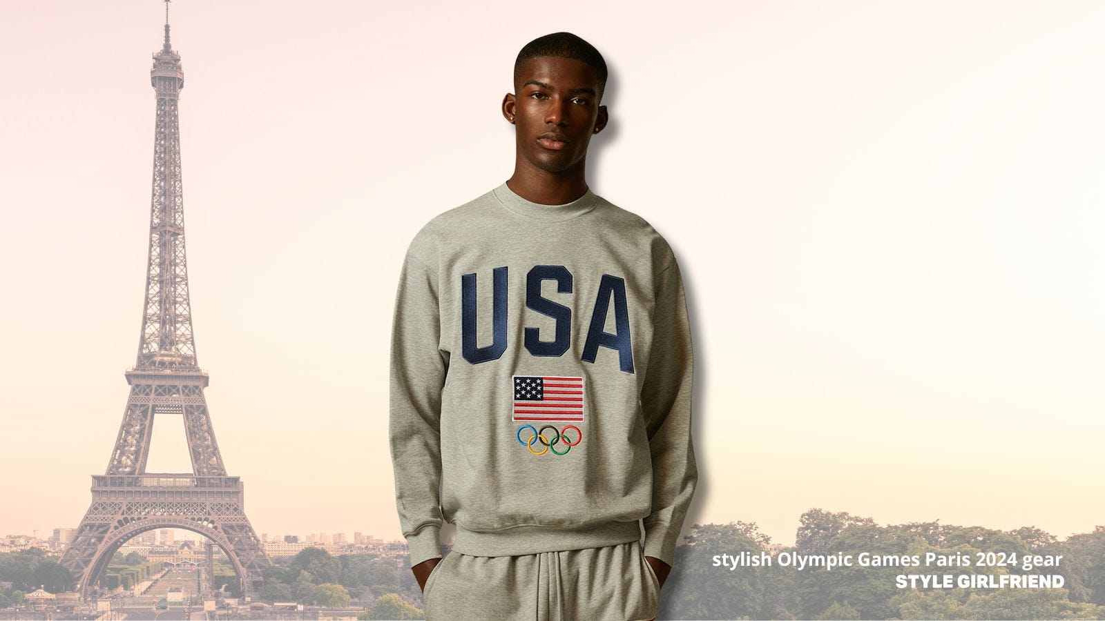 a man from the waist up wearing a grey USA Olympics sweatshirt