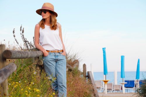 woman wearing relaxed white tank top at the beach