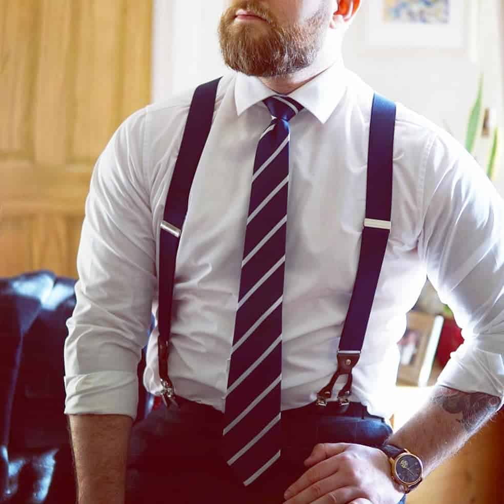 man in a shirt and tie wearing a blue suspender