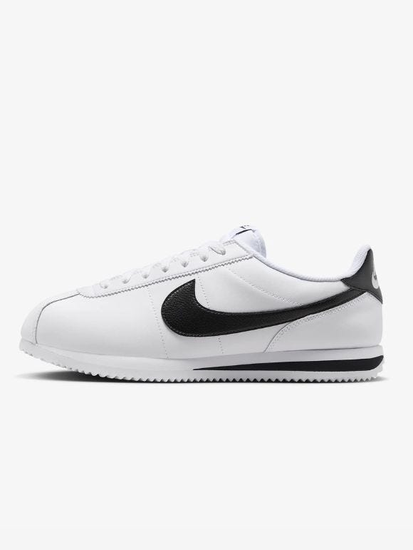 white nike cortez sneakers with black swoosh