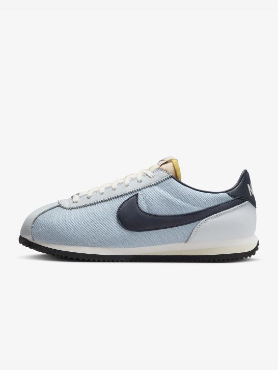 light blue nike cortez sneaker with navy swoosh