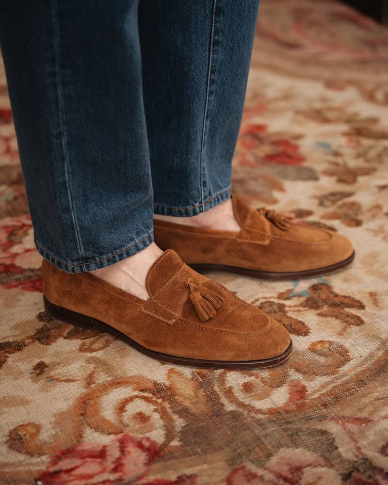 wearing a pair of brown suede tasseled loafers by Velasca