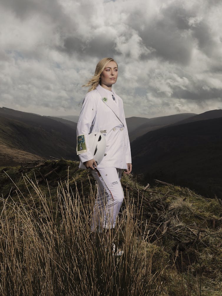 A woman stands in a field