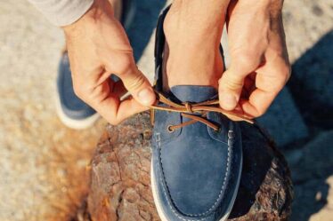 fixing a shoelace of a gambaree boat shoe by velasca